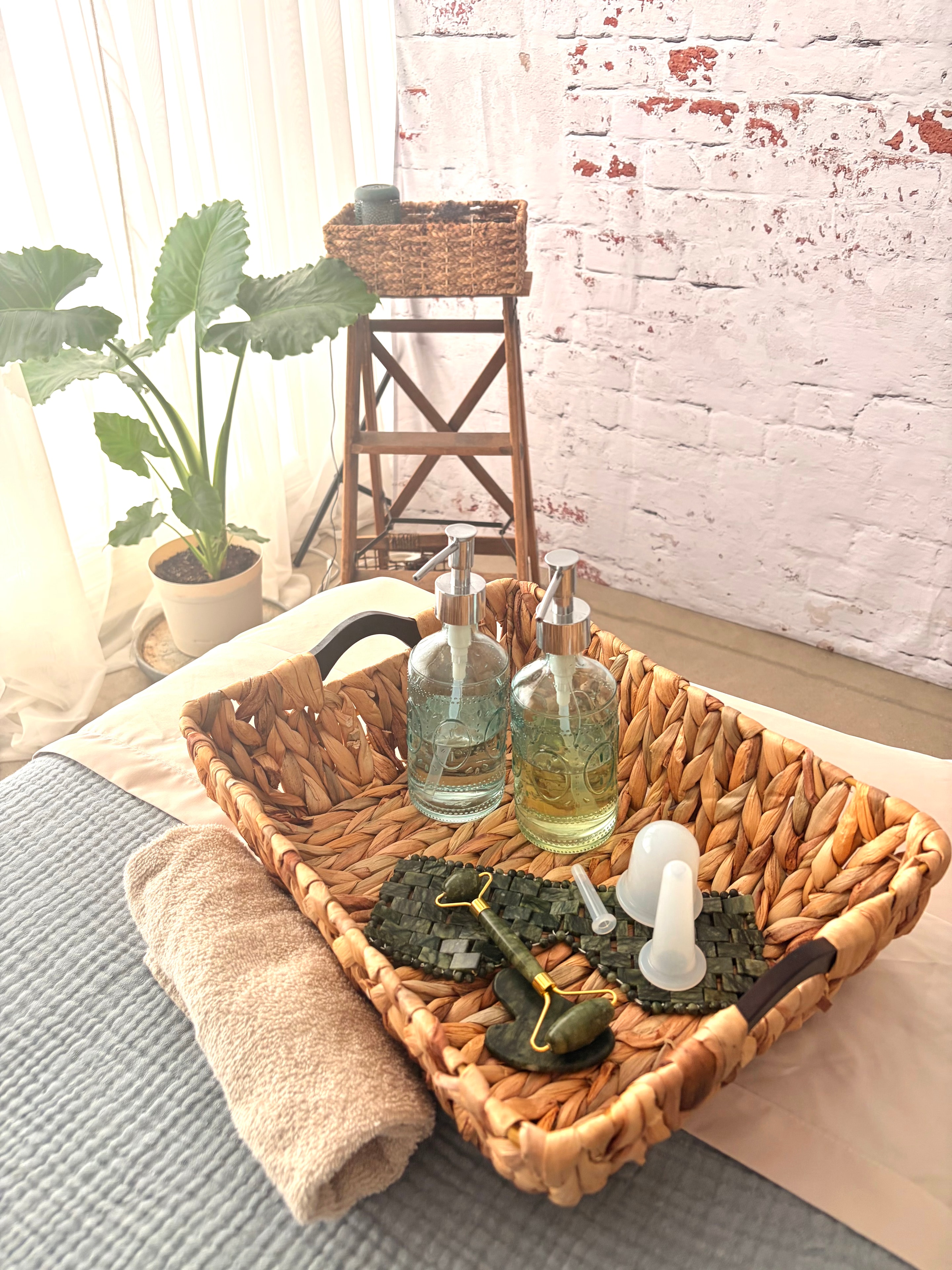 Gua sha facial therapy with rose quartz tool